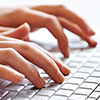 Business Administration student typing on a keyboard