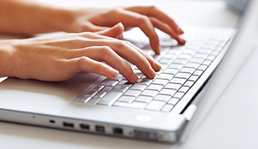 Business Administration student typing on a keyboard