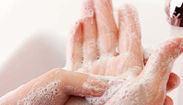 Closeup of postgraduate student washing their hands
