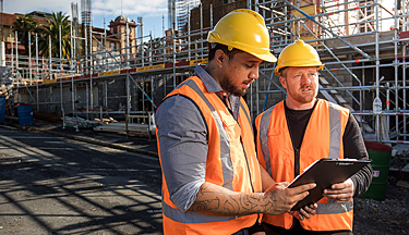 Tradesmen in hard hats on a construction 