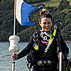 Marine scientist walking in the ocean at Mount Maunganui