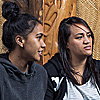 Group sitting on the floor of a marae having a conversation