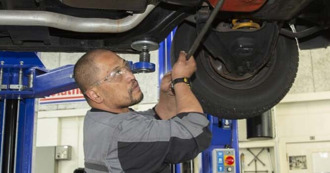 Student repairing a car in the garage at Toi Ohomai