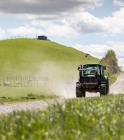 Tractor driving through farmland
