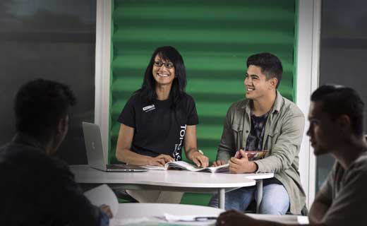 Student with tutor going through their assignment