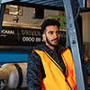 Student using a forklift while another student and tutor observe