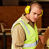 Student moving timber to be cut