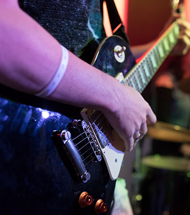 Closeup of hands on a guitar