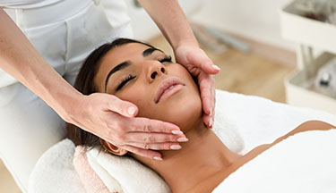 Beauty student giving client a facial