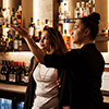 Student being taught by manager behind the bar