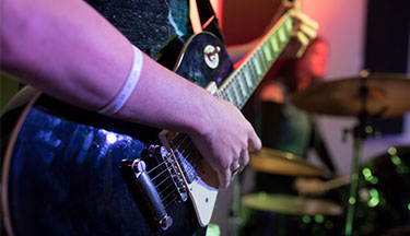 Closeup of hands on a guitar