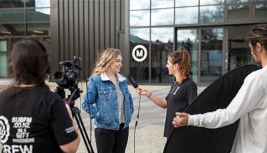 Media students interviewing student on campus