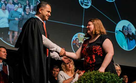 Graduate receiving certificate from tutor