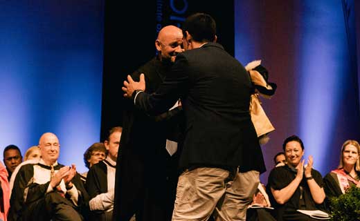 Graduand and tutor hongi