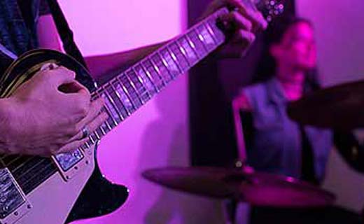 Music student playing guitar