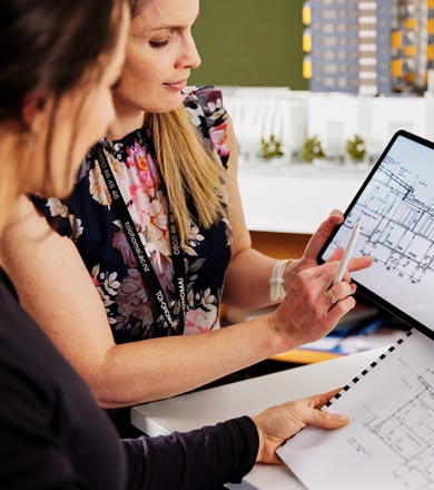 Tutor showing a student through an architectural drawing 