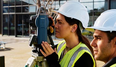 Students using a theodolite Surveying thumbnail image