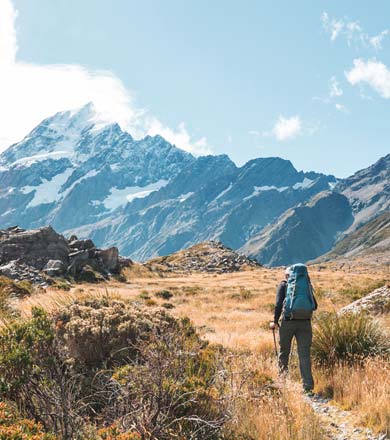 Student walking towards mountain ranges in New Zealand