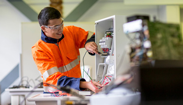 Electrical student working on a circuit Electrical student working on a circuit
