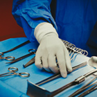 Surgeon picking up some scissors Surgeon picking up some scissors