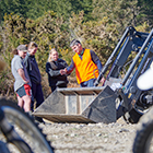 Heavy Automotive Engineering students surrounding a tractor with their tutor