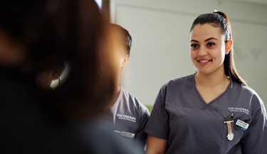 Nursing student interacting with a patient