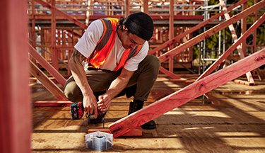 Carpentry student drilling in a screw