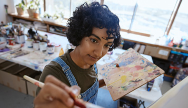 Art student painting on a canvas
