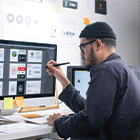 Creative student reviewing their work through the computer screen