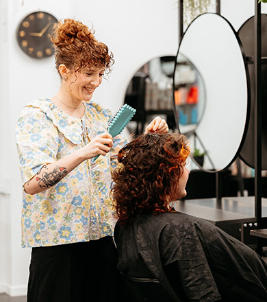 Toi Ohomai Hairdressing student brushing clients hair