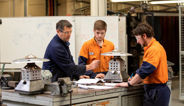 Engineering students with tutor