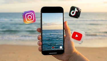 Student using smartphone at the beach