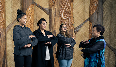 Students performing waiata with tutor