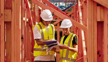 Construction Management students looking over building plans