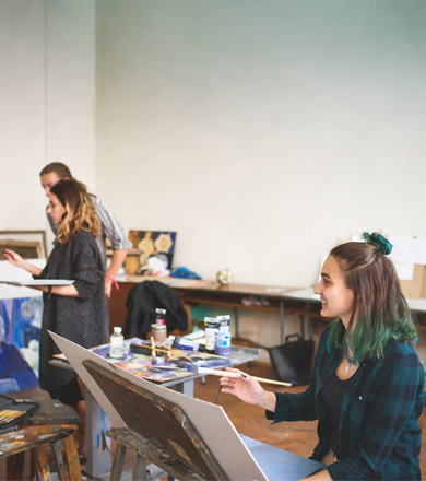 Creative students in class working on their art