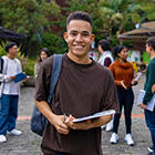 International student standing with his friends