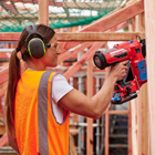 Carpentry students using a nail gun