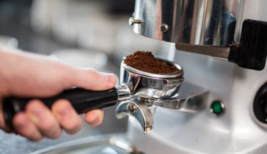 Barista student making a coffee