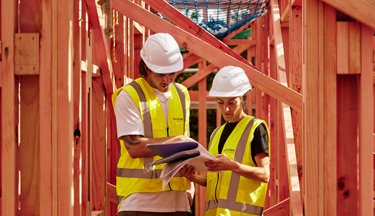 Construction Management students looking over building plans