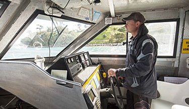 Maritime student operating a boat