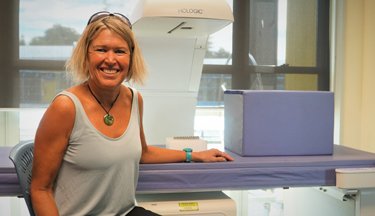 Dr Tracey Clissold with the DEXA machine