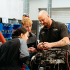Automotive tutor taking students through a car engine