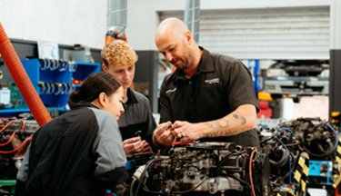 Automotive tutor taking students through a car engine
