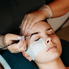 Beauty student working on a client's eyebrows
