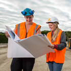 Engineering students looking over plans