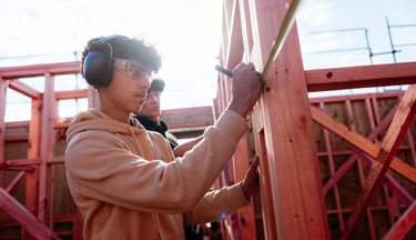 Construction student marking out a measurement