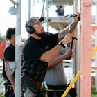Carpentry tutor hammering in a nail