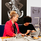 Fashion tutor overseeing their students work