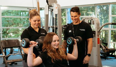Sport students in the gym with their tutor