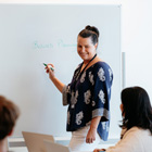 Business tutor teaching a class